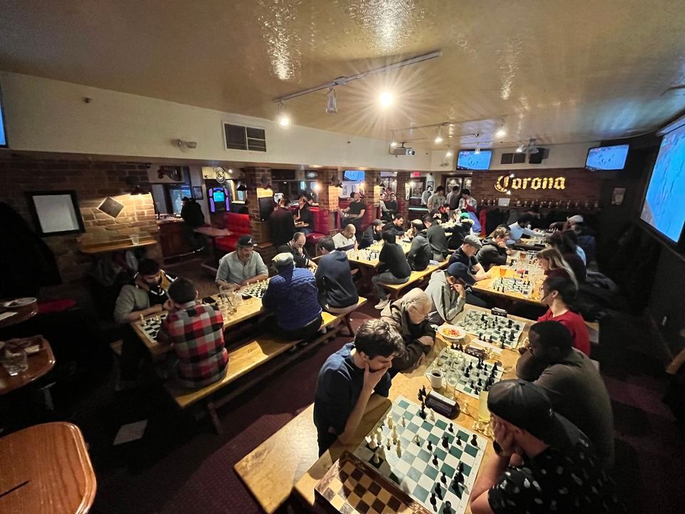 people playing chess in a bar