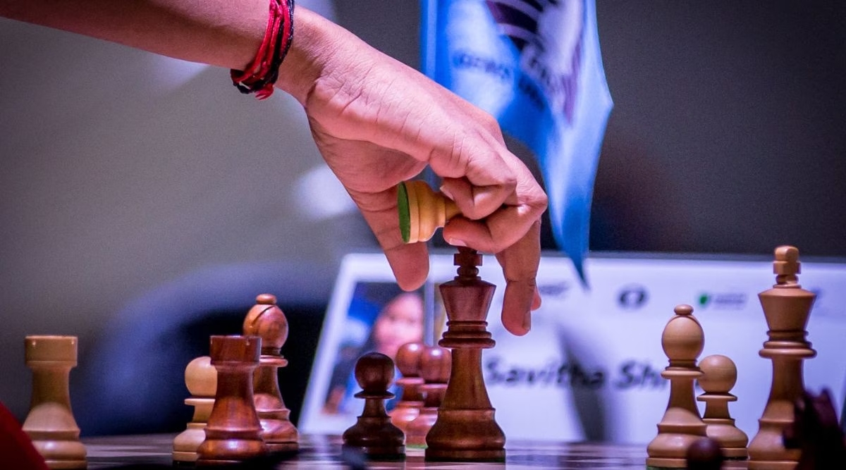 Hand reaching for chess piece